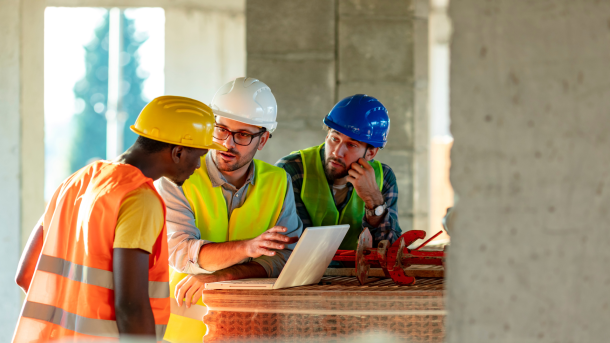 Image of construction workers with a laptop